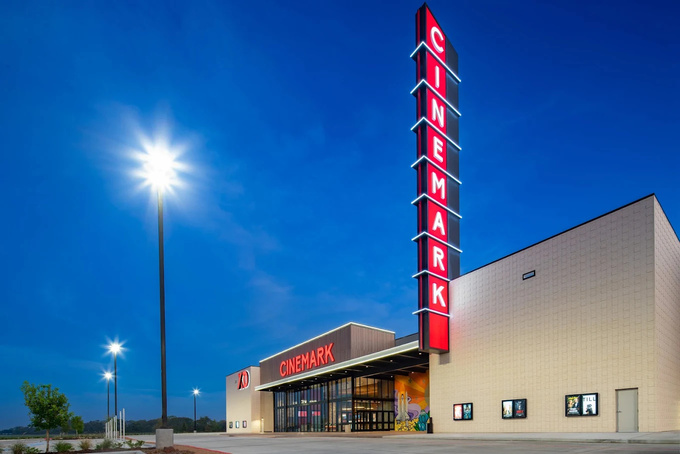 Cinemark theater entrance at night with illuminated signage